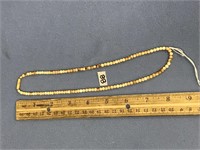 Fossilized ivory necklace with seed-like bead neck