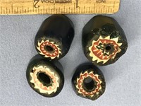 Four old trade beads, two blue and two green