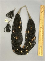 Woman's matching heavily beaded necklace and match