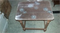 OLD WOODEN STOOL WITH CLOTH SEAT AND DESIGN ON TOP