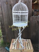 Large metal bird cage on stand