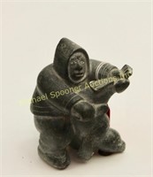 SIGNED INUIT STONE SCULPTURE OF HUNTER WITH CATCH