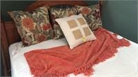Four pillows and bed throw