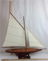 Wooden model sailboat with cotton sails