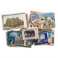 Four large bags of vintage postcards