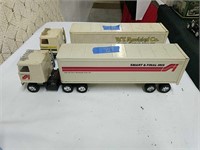 Two vintage tin toy tractor trailers as shown