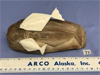 Portion of a walrus skull, relief carved with a ha