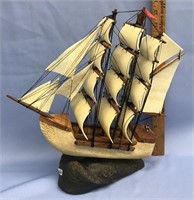 Bone, walnut, and hide sailing ship, triple masted