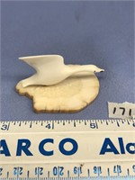 Flying bird, 2.25" long on fossilized ivory base