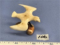 Carved 2" fossilized ivory bird on fossilized ivor