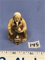 Ivory carving of man with teapot, Netsuke 2"