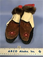 A pair of child's mukluks with otter fur and beade