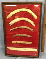 A framed group of St. Lawrence island bone artifac
