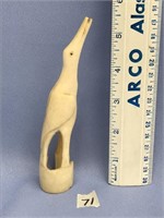 5 1/2" tall, carving of a cormorant out of fossili