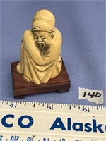 Ivory carving of an old man on wood base, 2.75" ta