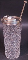 A crystal cocktail shaker with sterling rim