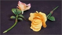 A pair of porcelain roses with stems, marked
