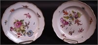 Two 8" hand-painted floral plates with Meissen