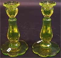 A pair of 8" vaseline glass candlesticks