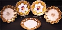 Five decorative plates, all with heavy gold