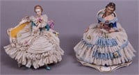 A pair of sitting Dresden figurines, one