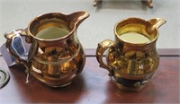 2 copper washed ceramic pitchers