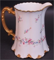 A 9" Haviland pitcher with gold handle and