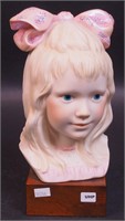 A Cybis bust of little girl on wood base, 10"