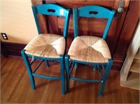 2 green wood chairs w/ wicker seats