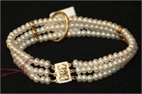 14kt yellow gold triple strand Pearl Bracelet &