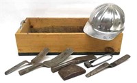 Wooden crate with cement hand tools and hard hat