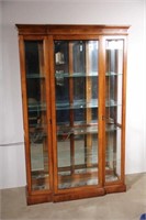 large oak finished curio cabinet with double