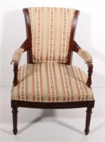 upholstered arm chair with carved leg facias,