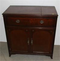 mahogany cabinet with lifting lid to storage