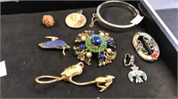 Group of costume jewelry including a brooch,