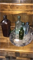 Five antique bottles, including an amber water