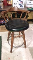 Barstool with a vinyl padded seat and foot rest,