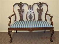 Carved back settee on carved cabriole legs