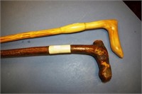 Two various early wooden walking sticks