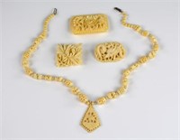 FOUR IVORY CARVED JEWELRY PIECES