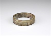 MING OLIVE AND RUSSET JADE ARCHAISTIC BANGLE