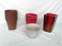 Group of planter pots with red glass vase
