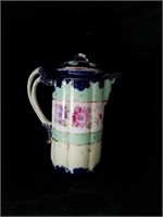 Vintage porcelain tea pot with floral pattern