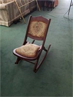Antique rocking chair with floral pattern