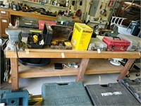 Large wooden workbench with small red Vice