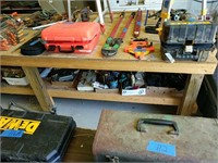 Large wooden workbench on rollers includes items