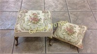 Small tufted floral themed footstool with brass