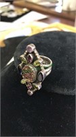 Silver tone ring marked 925 with amethyst stones,