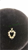 Gold tone heart pendant marked 10K with clear and