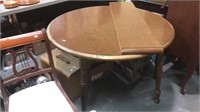 Round formica top kitchen table with one leaf,